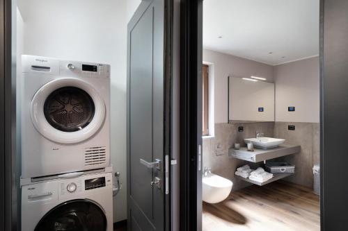 a bathroom with a washing machine and a sink at Agriturismo il Borgo - Ulivo in Villanova dʼAlbenga