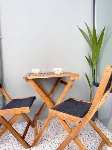 a wooden table and two chairs next to a table at green guest house. Figueira da Foz in Figueira da Foz