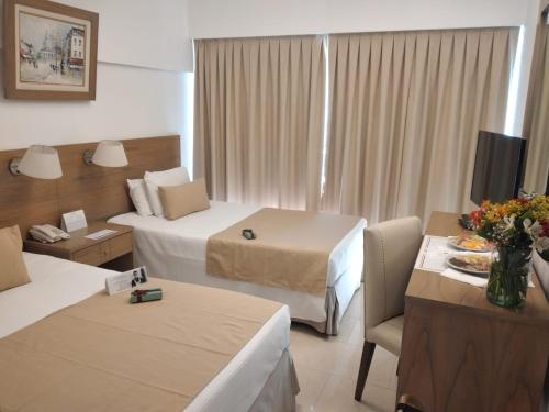 a hotel room with two beds and a television at Globales Republica in Buenos Aires