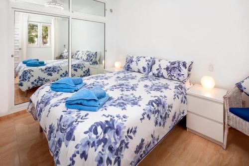 a bedroom with two beds and a mirror at Las Palmas 2a Oasis Properties in Nerja