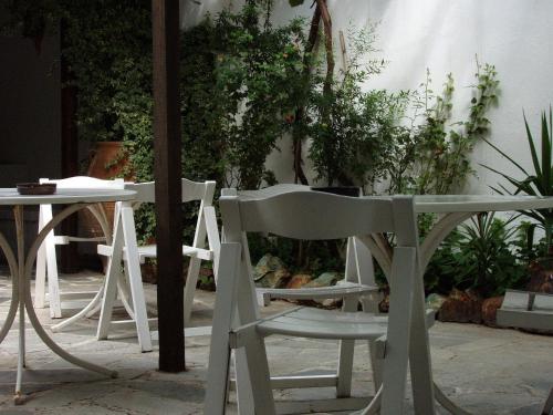 two white chairs sitting next to a table at Hotel Hellinikon in Ouranoupoli