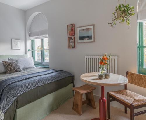 a bedroom with a bed and a small table at Mason & Fifth, Bermondsey in London