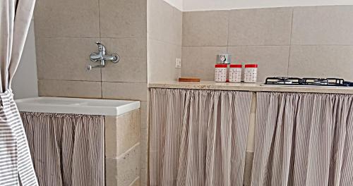 een badkamer met een wastafel en een fornuis bij COLOMBO casa per vacanze in corte salentina in Matino