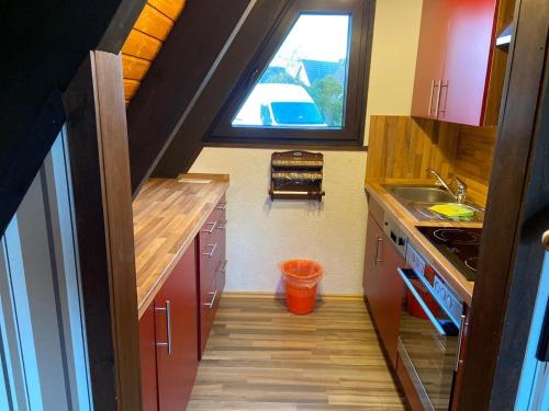 a small kitchen with a sink and a window at Ferienpark Fedderwardersiel in Fedderwarderdeich