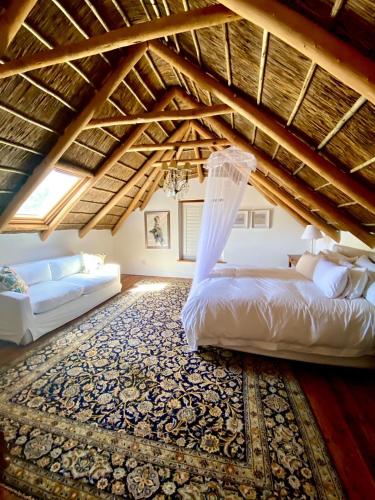 a bedroom with a large bed and a rug at The Burrow in Tulbagh
