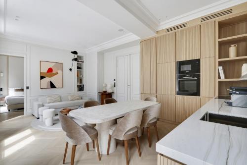 a kitchen and living room with a table and chairs at TheLander - Serviced Apartments in Louvre - Rivoli in Paris