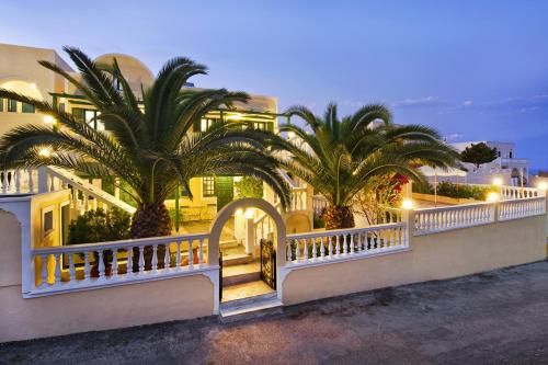 a building with palm trees in front of it at Phoenix in Fira
