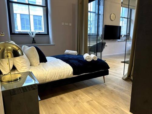 a bedroom with a bed and a glass table at Stunning 2BR Apt in Central Manc in Manchester