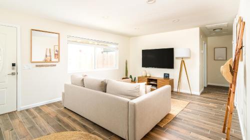 a living room with a couch and a tv at Red Rock - Desert feel - Game Room in Joshua Tree