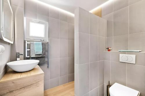 a bathroom with a white sink and a toilet at Villa KIP, private pool & jacuzzi surrounded by nature in Pinar de Campoverde