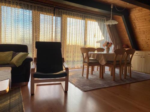a living room with a dining room table and chairs at Ferienpark Fedderwardersiel in Fedderwarderdeich