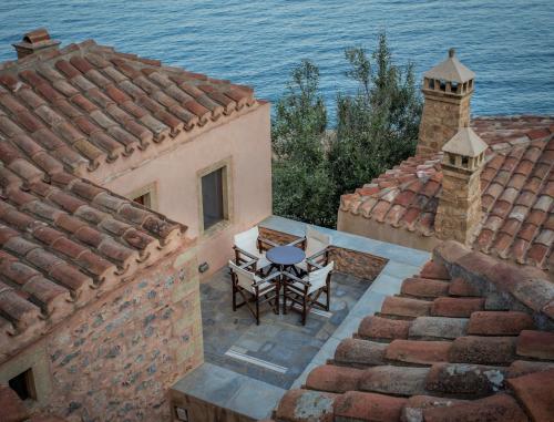an aerial view of a house with a table on the roof at Bastione Malvasia Hotel (ex New Malvasia) in Monemvasia