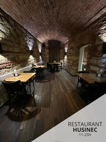 a restaurant with wooden tables and a brick wall at Wenceslas Square Hotel - Czech Leading Hotels in Prague