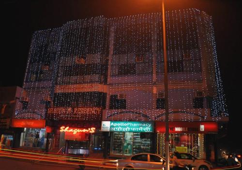 a building with christmas lights on the side of it at Shagun Residency Panipat in Pānīpat