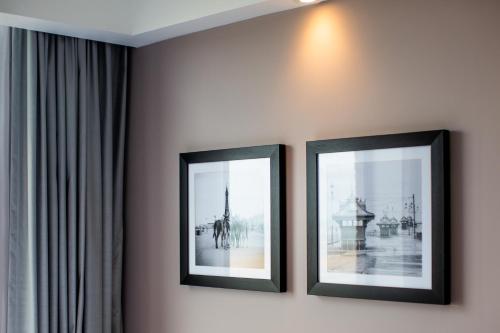 two framed pictures on a wall in a room at Hampton By Hilton Blackpool in Blackpool