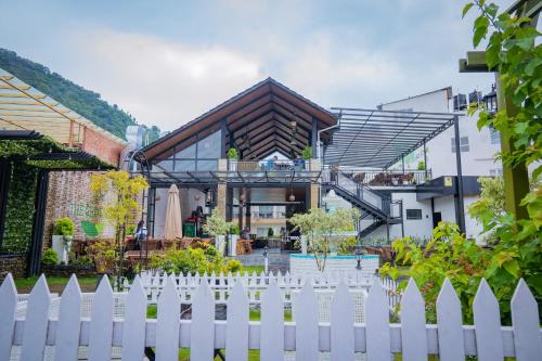 a white picket fence in front of a house at Majestic Lake Front Hotel & Suites in Pokhara