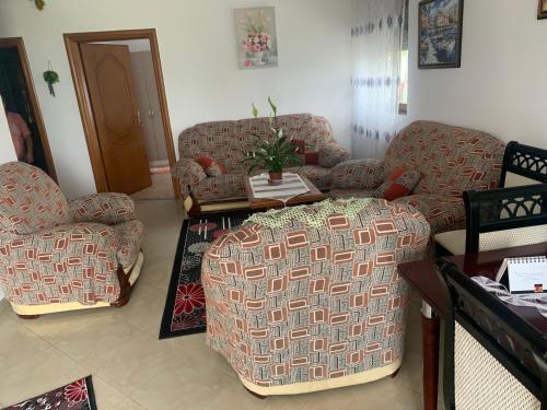 a living room with two chairs and a table at Villa Rejan in Pogradec