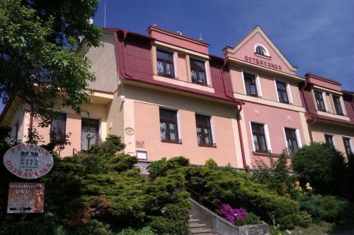 a pink building with a sign in front of it at Penzion Ostravanka in Hranice