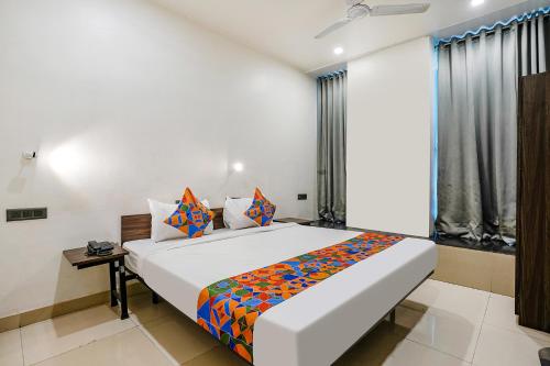 a bedroom with a large bed in a room at FabHotel Lotus I in Surat