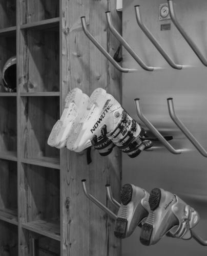 a group of shoes are hanging on a wall at Ragitt Stodl Ferienwohnungen in Vols am Schlern