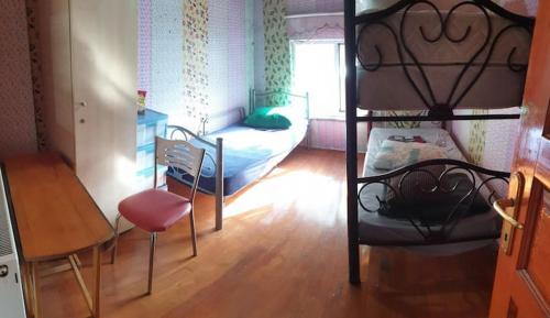 a bedroom with a bunk bed and a table and a chair at Men's Hostel in Fatih, Istanbul in Istanbul