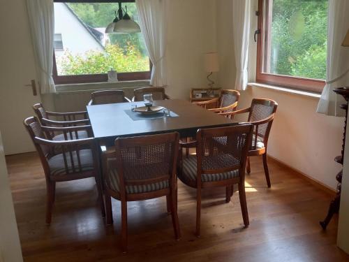 a dining room with a table and chairs and a window at Holiday home with garden in Hellenthal Eifel in Hellenthal