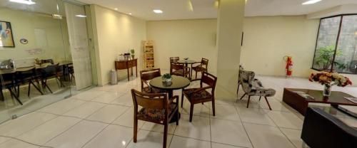 a dining room with tables and chairs in a room at Hotel Recanto Vip in Araripina