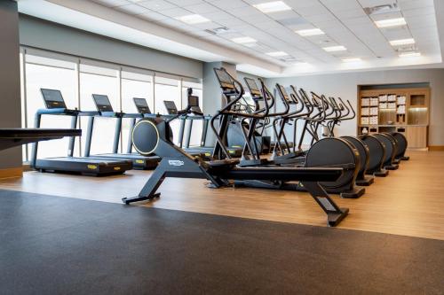 a gym with rows of treadmills and ellipticals at Sheraton Phoenix Downtown in Phoenix