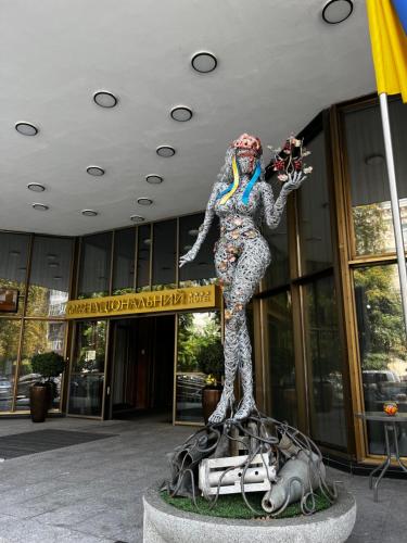 a statue of a woman standing in front of a building at Natsionalny Hotel in Kyiv