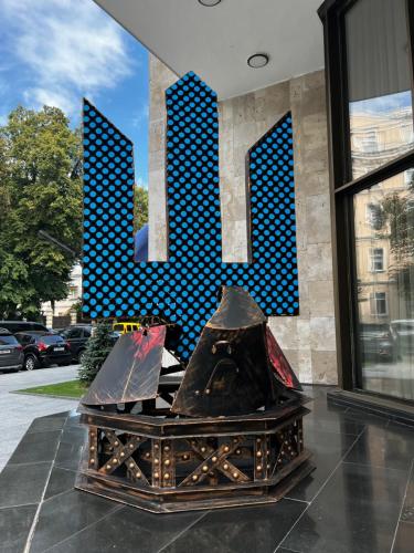 a large building with a large letter m on it at Natsionalny Hotel in Kyiv
