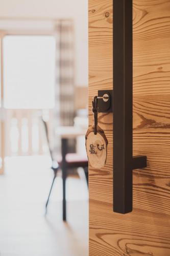 a locked door with a padlock on it at Ragitt Stodl Ferienwohnungen in Vols am Schlern