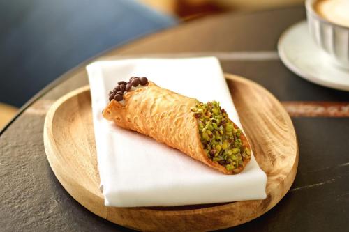 a plate with a piece of food on a table at Sheraton Zagreb Hotel in Zagreb