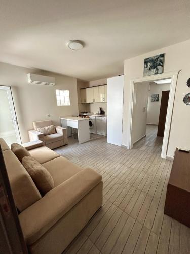a living room with a couch and a kitchen at Loca Centre Suites in Bodrum City