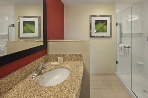 a bathroom with a sink and a shower at Courtyard Philadelphia Coatesville Exton in Coatesville