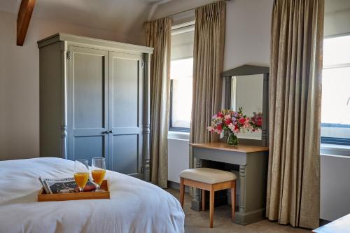 a bedroom with a bed with a mirror and a desk at The Filly in Hexham