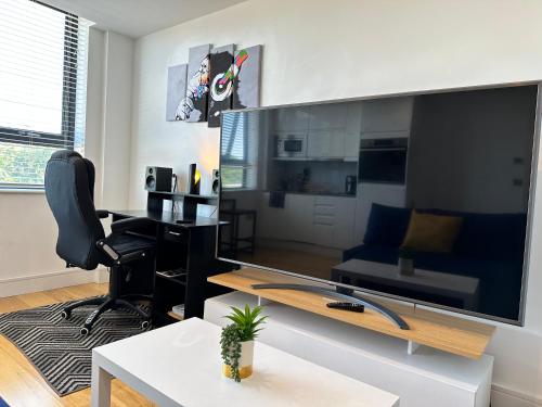 a living room with a large flat screen tv at Comfort Stay Apartment in Haywards Heath
