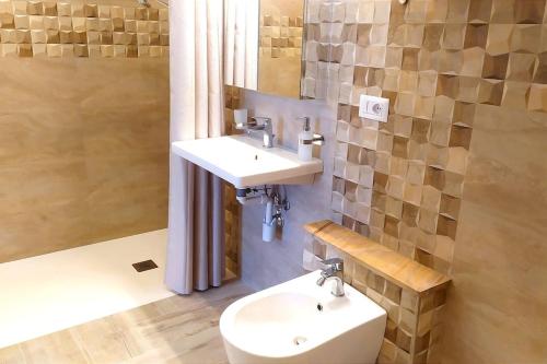 a bathroom with a sink and a toilet at Villino rosso in Taormina