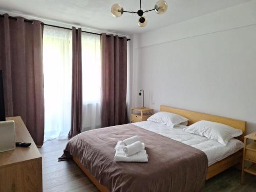 a bedroom with a bed with two towels on it at CITADEL VIEW in Tîrgu Neamţ
