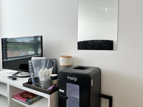 a desk with a computer monitor and a printer at Comfort Stay Apartment in Haywards Heath