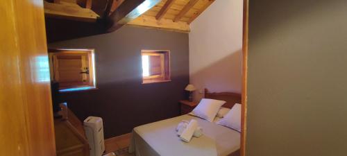 a bedroom with a bed with two towels on it at Posada de Serrada in Serrada de la Fuente