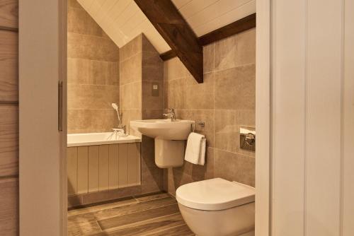 a bathroom with a toilet and a sink at The Clocktower in Hexham