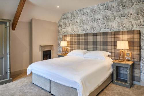 a bedroom with a large white bed and two lamps at The Foal in Hexham