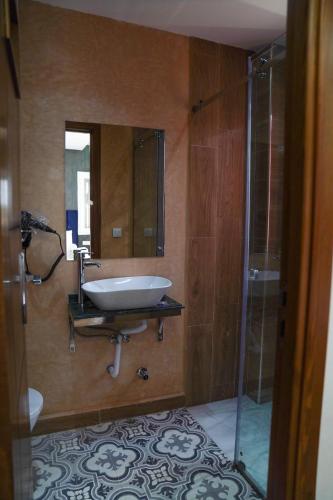 a bathroom with a sink and a glass shower at CASA DEL TITO in Oulad Akkou