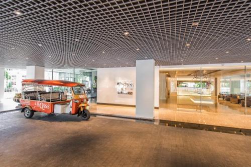a room with a small vehicle in a building at Qiss Residence by Bliston in Bangkok