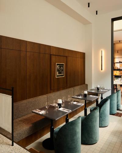a dining room with tables and blue chairs at Morgan & Mees Rotterdam in Rotterdam