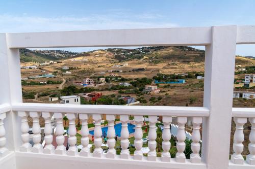a white balcony with a view of the mountains at CASA DEL TITO in Oulad Akkou