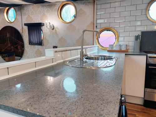 a kitchen with a sink and a counter top at Titanic Boat in Liverpool