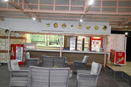a restaurant with a bunch of chairs and a counter at Sunset Village in Didim
