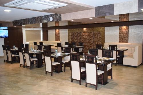 a restaurant with tables and chairs and a couch at Hotel Star Palace - Rameswaram Tamil Nadu in Rāmeswaram