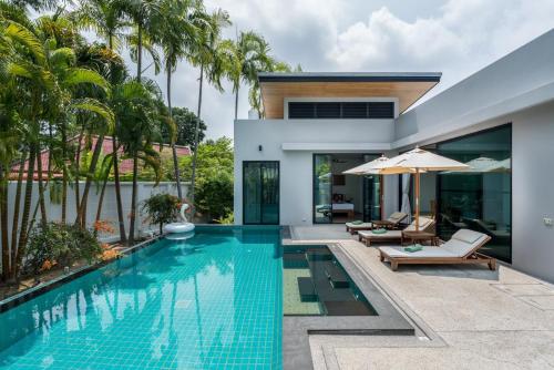 a swimming pool in the backyard of a villa at Ban Bua Lux x MonthStayz Thailand in Rawai Beach
